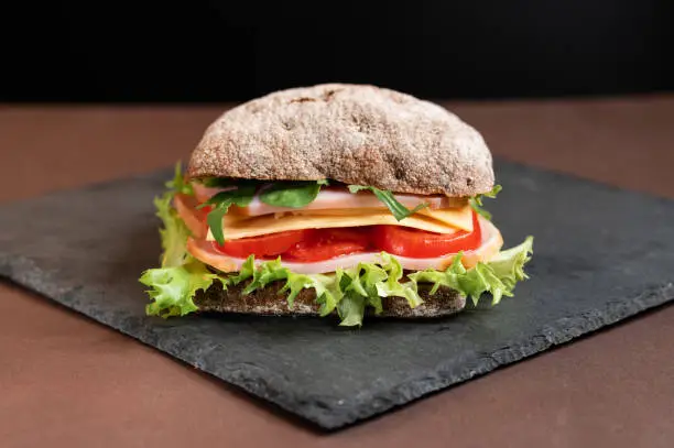 Photo of Sandwich on a slate board. Sandwich from the menu.