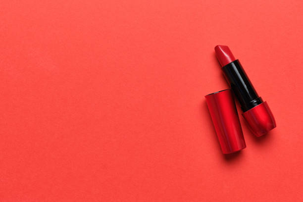 istock Red lipstick on a red background with copy space. 1255718145