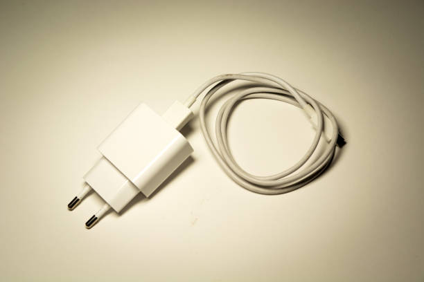 istock White phone charger with rolled-up cable 1255718316