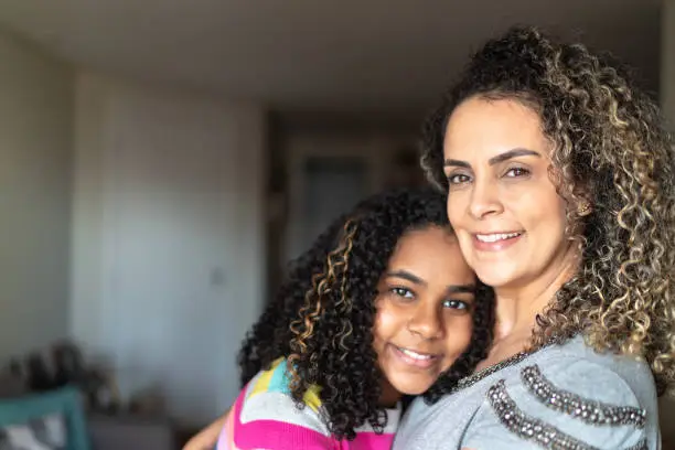 Photo of Portrait of mother and daughter embracing