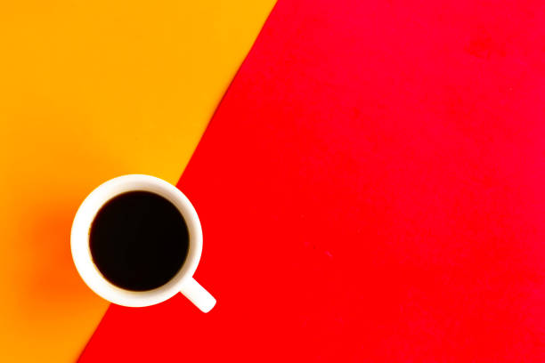 istock Coffee cup on geometric orange and red background, top view, copy space for the text, minimal concept 1255718491