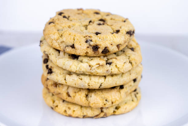 istock fresh baked classic chocolate chip cookies with nuts on a plate 1255718631