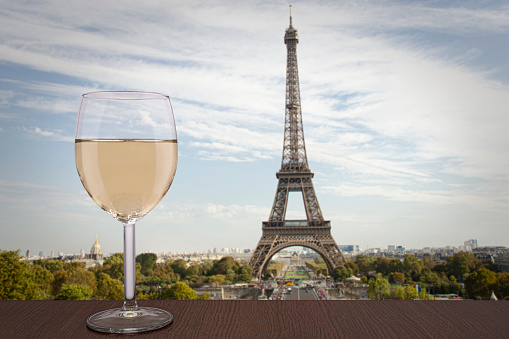 Glass of white wine with Eiffel tower view in Paris, France