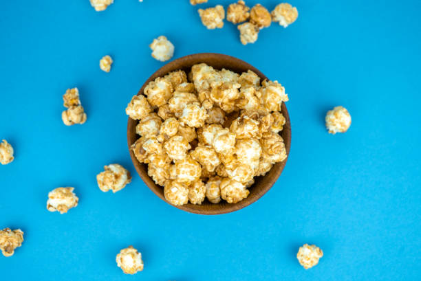 istock wooden bowl of fresh popcorn with caramel 1255722575