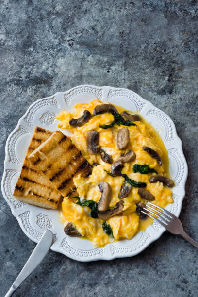 istock creamy scrambled eggs with mushrooms and spinach 1255722587