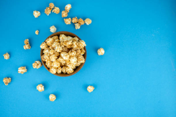 istock wooden bowl of fresh popcorn with caramel 1255722589
