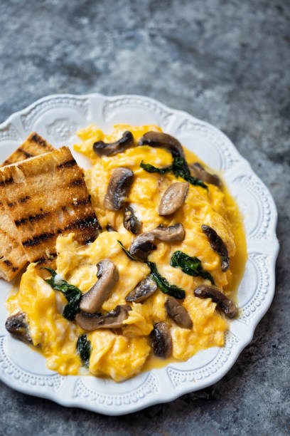 istock creamy scrambled eggs with mushrooms and spinach 1255722650