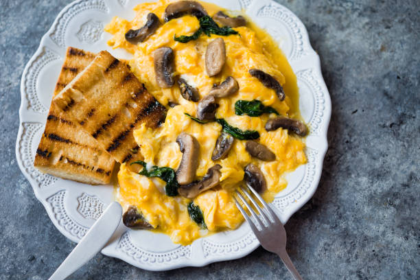 istock creamy scrambled eggs with mushrooms and spinach 1255722662