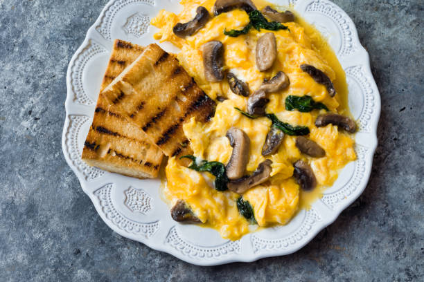 istock creamy scrambled eggs with mushrooms and spinach 1255722724