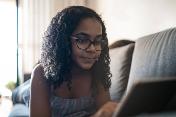 istock Teenager reading on digital tablet at home 1255722806