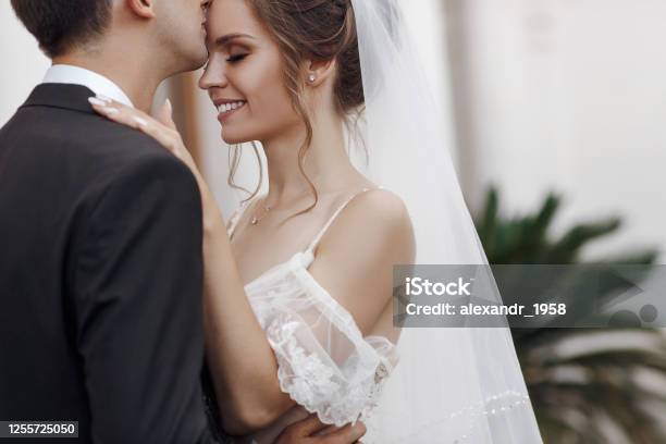 Happy Couple In Love Bride And Groom Cuddle And Look At Each Other Stock Photo - Download Image Now