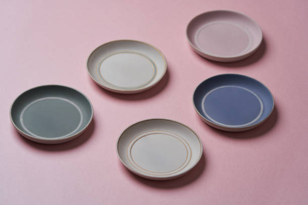 istock Colorful plates on pink background with copy space. 1255728608