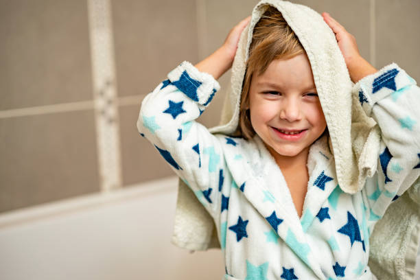 Smiling boy drying hair after bathing