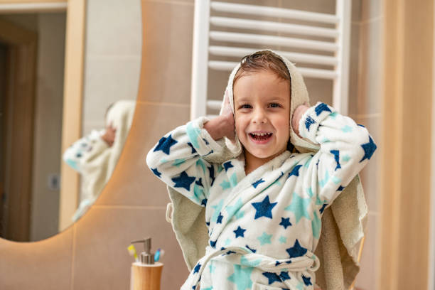 istock Little boy is drying hair after shower 1255729473