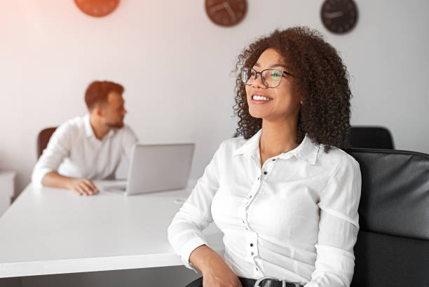 istock Black woman dreaming in office 1255731269