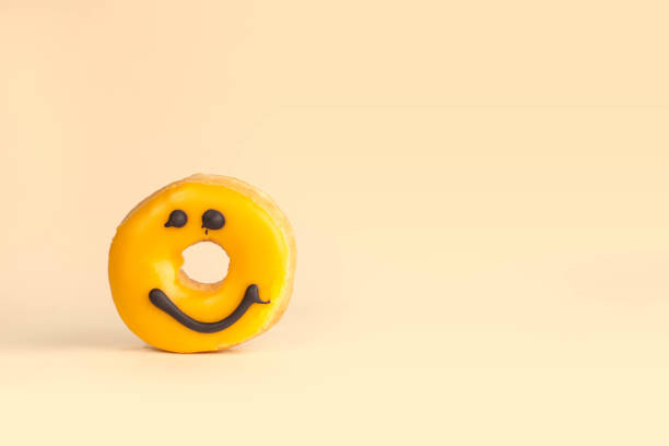 istock yellow donut with a chocolate smile 1255732662