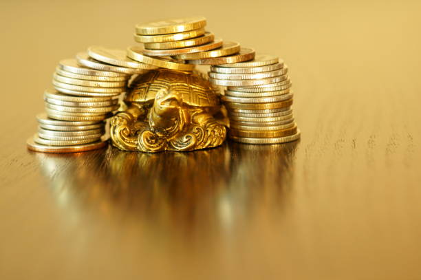 istock Metal turtle on a gold background. 1255733977