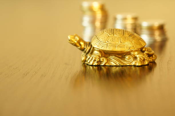 istock Metal turtle on a gold background. 1255734023