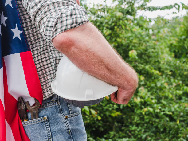 istock Handsome man with tools, holding an American Flag 1255734989