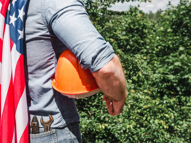 istock Handsome man with tools, holding an American Flag 1255735088