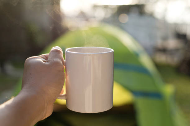 istock Close-Up Of Hand Holding Coffee Cup By Tent 1255735742