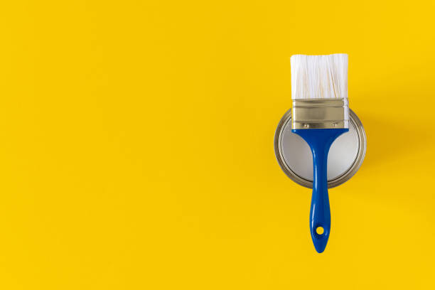 istock Can of white paint with a brush 1255737677