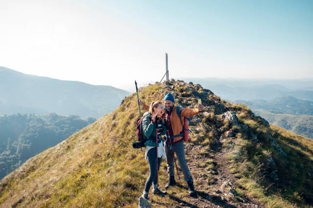 istock Young couple taking a selfie while out hiking 1255739352