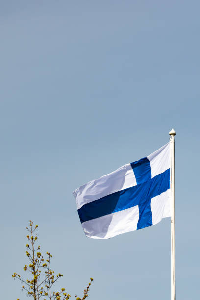 istock Finnish national flag on the wind against the blue sky 1255739639
