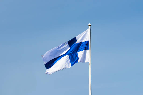 istock Finnish national flag on the wind against the blue sky 1255739646