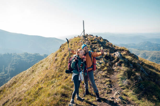 istock Young couple taking a selfie while out hiking 1255739761