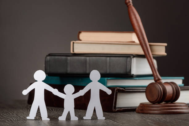 istock Paper people chain, books and judge's gavel 1255741584