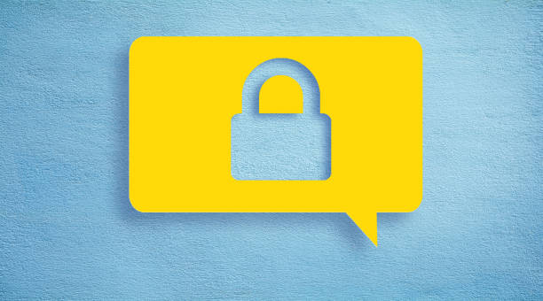 Security concept chat bubble. Online security and protection concept, padlock icon or sign on vibrant yellow speech bubble on blue color real concrete wall with copy space. locking photos stock pictures, royalty-free photos & images