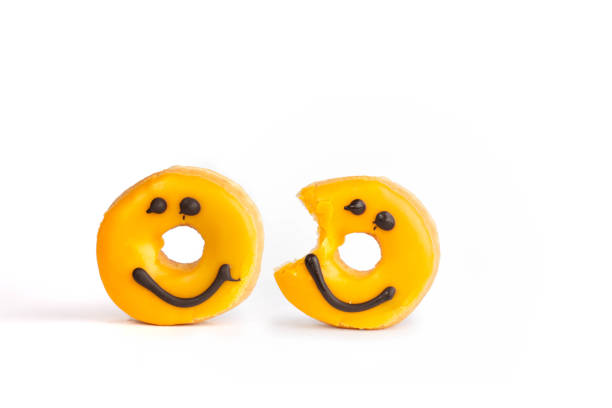 istock two Fresh yellow donuts with a chocolate smile 1255741656