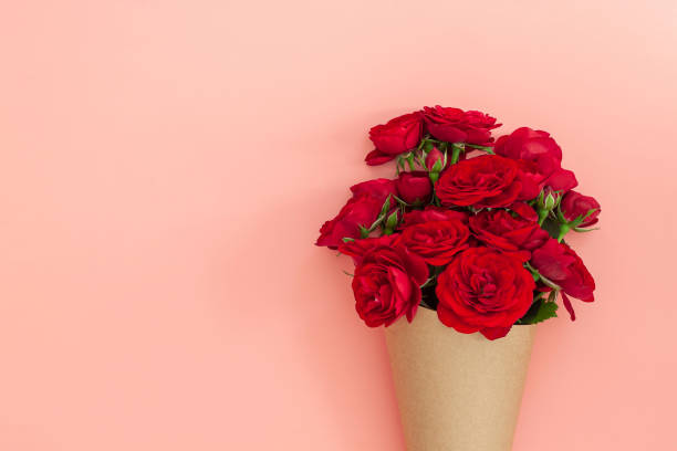 istock Red rose bouquet wrapped vintage craft paper. 1255742153