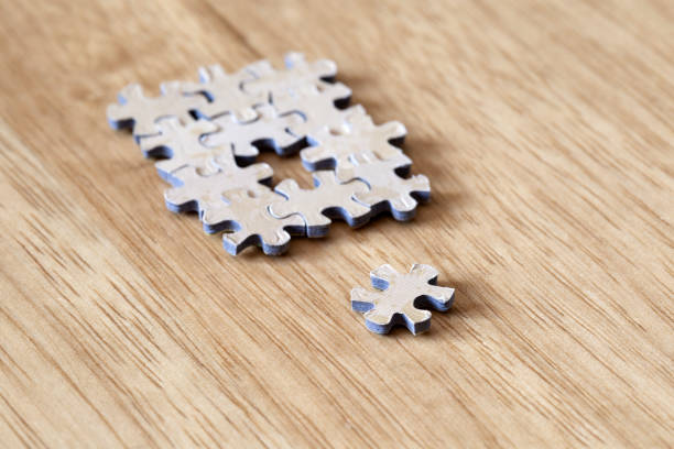 istock Blank puzzle pieces on wooden background texture, business and connection concept. space for text. 1255742702