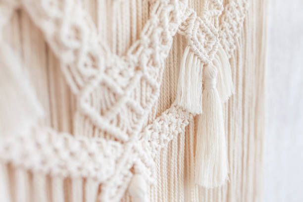 istock Close-up of hand made macrame texture pattern.  ECO friendly modern knitting DIY natural decoration concept  in the interior. Flat lay. Handmade macrame 100% cotton. Details close up. Female hobby. 1255742920