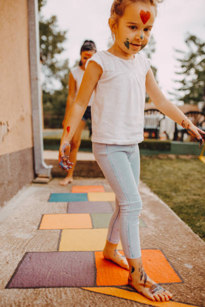 istock Active little girl enjoying playing hopscotch 1255744133