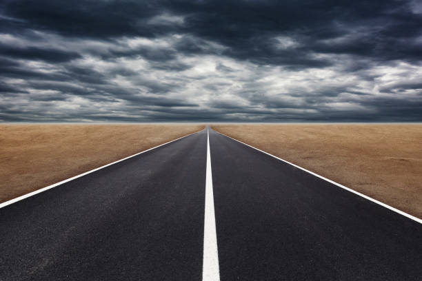 istock Empty asphalt street road to infinity highway in cloudy day. 1255744228