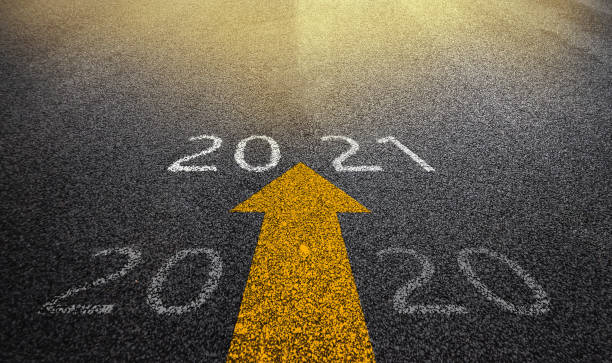 istock Empty asphalt street road and writing text 2020 and 2021 on roadway. 1255744278