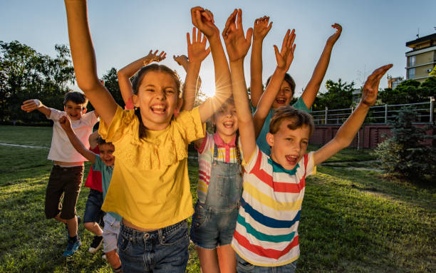 istock Happy children running in public park 1255744367