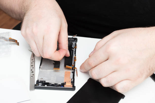 istock Replacing defective modules in a mobile phone. The wizard collects a smartphone from the details 1255749440