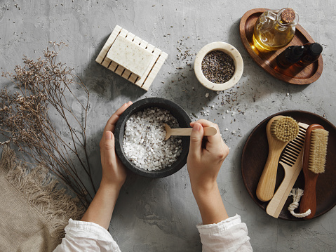 Woman making homemade bath salt with lavender