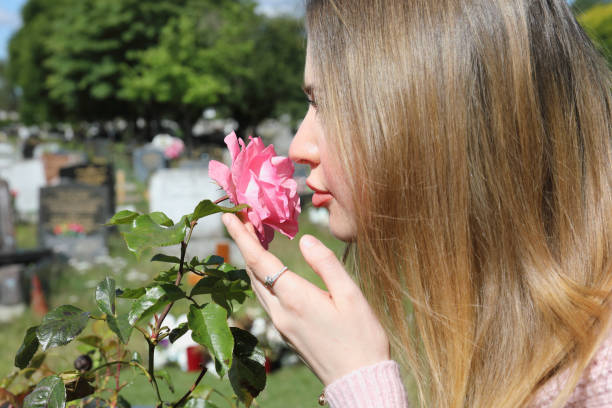 istock Smelling a pink rose during Covid-19 lockdown 1255754934
