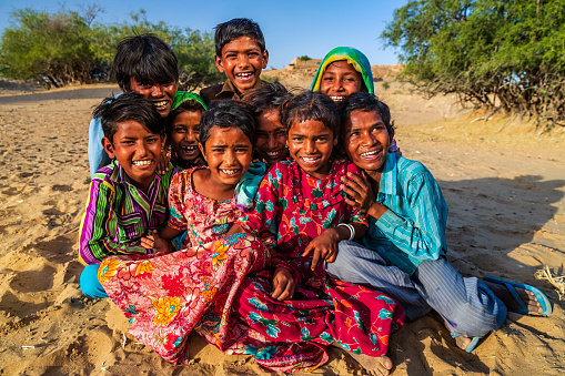 Group of happy Gypsy Indian children - desert village, Thar Desert, Rajasthan, India.