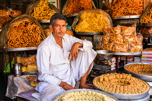 Indian street vendor selling sweets near Jaipur. Jaipur is the capital city of Rajasthan. Jaipur is known as the Pink City, because of the color of the stone exclusively used for the construction of all the structures.
