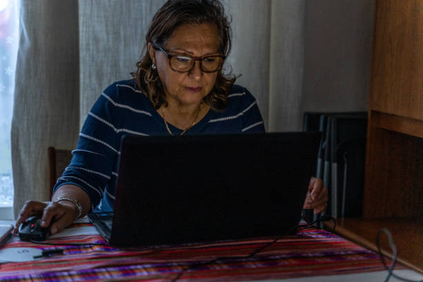 istock Attractive senior Hispanic at laptop 1255756839