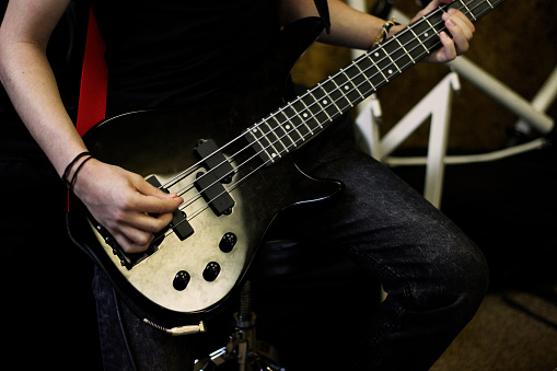 Person playig concert on a bass guitar.