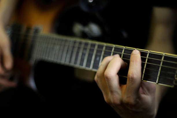 istock Person playig concert on a guitar 1255759511