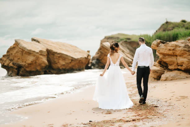 istock young couple groom with the bride on a sandy beach 1255761497
