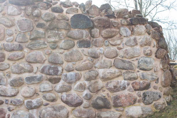 istock Part of ancient fortress stone wall. Natural background or texture. Front view. 1255763341